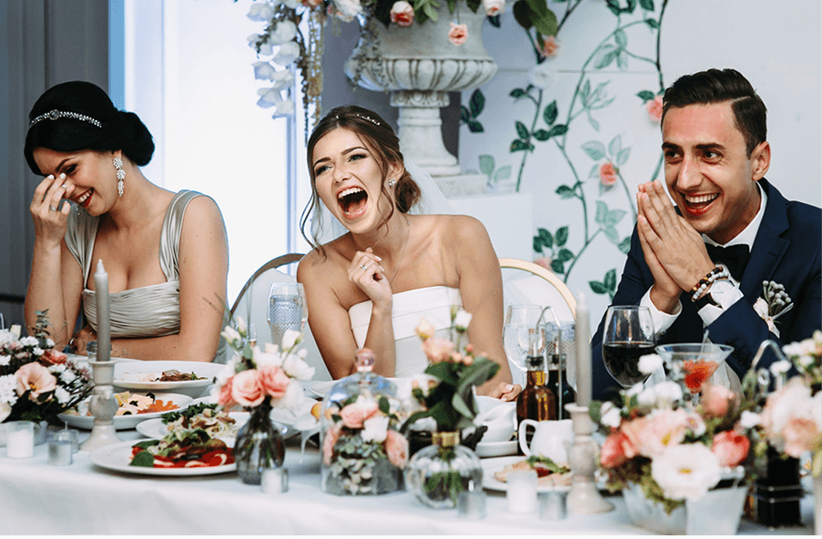 family laughing at a wedding